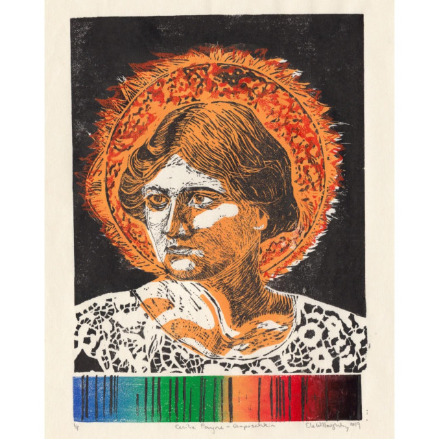 My linocut portrait of astronomer Cecelia Payne-Gaposchkin: At the bottom there’s a thin horizontal rectangle with a rainbow roll from left to right of indigo, blue, green, yellow, orange, red and black. The rectangle has a series of discrete thin vertical black stripes as this is a solar absorption spectrum. Above is Cecilia Payne-Gaposchkin’s face and neck and a halo made by the shape of the sun in yellow and orange against a black background of outer space. She is serious young woman with a bob and a wide lace collar. Shading on her face is in the yellow of the sun.