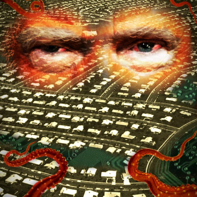 An aerial image of the planned city of Levittown, tinted light green. A circuit board bleeds through the open spaces on the town plan. Hovering over the town are Trump's disembodied, bloodshot eyes, in pouchy orange nests. Orange tentacles swarm over the town.