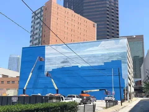 Crews paint over the Whaling Wall mural in downtown Dallas in preparation for a lousy FIFA world cup ad 