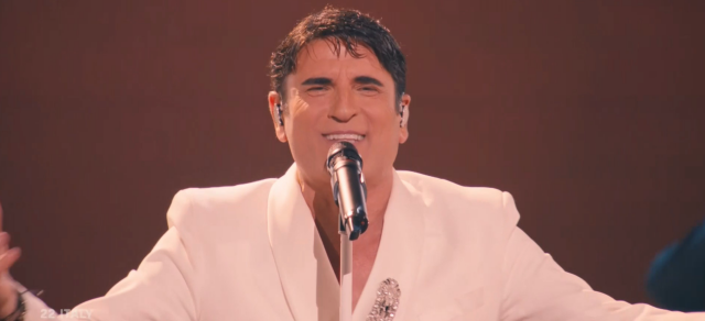 Italian singer that looks like Tony Montana in his white suit