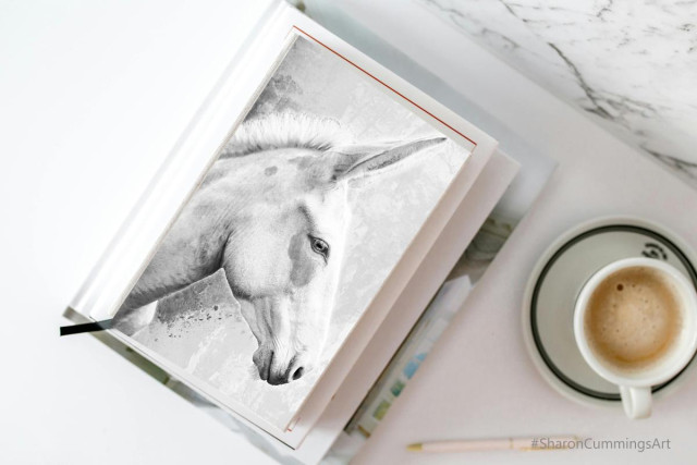 Black and white donkey art by Sharon Cummings on a journal.