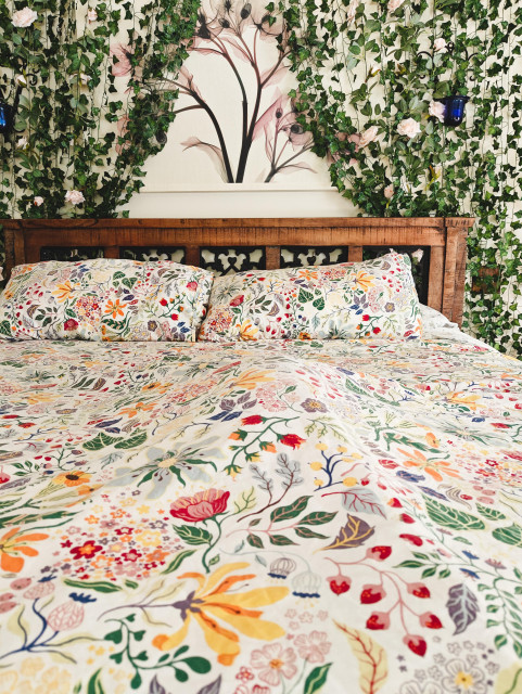 A bed. There's a lump under the comforter.
