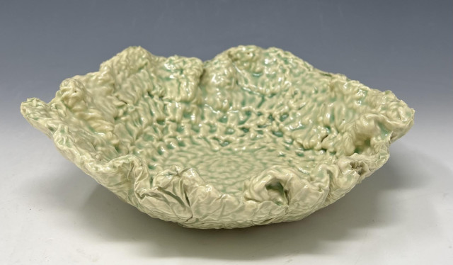 Crocheted-ceramic bowl dipped once in Korean Celadon glaze, positioned right-side up. It shows off the texture of the crocheted fabric nicely.