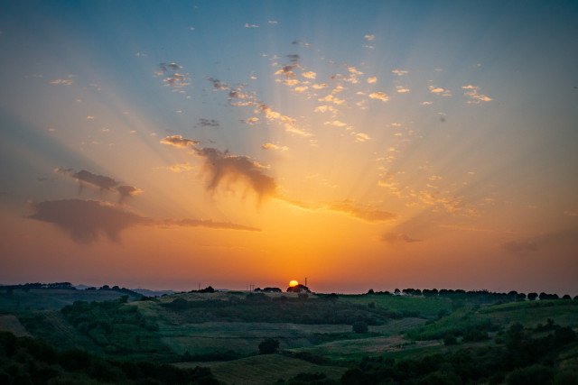 sunset seen over hilly farmland in Portugal