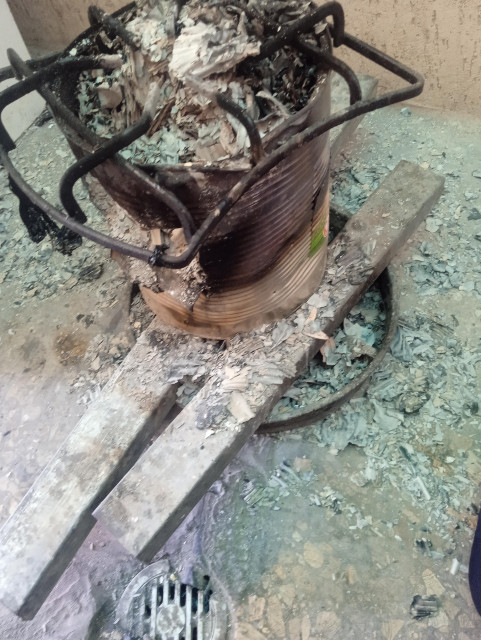 Using fire by burning plastic due to the lack of cooking gas in Gaza, a stove with burnt-out paper on it is used to cook food.