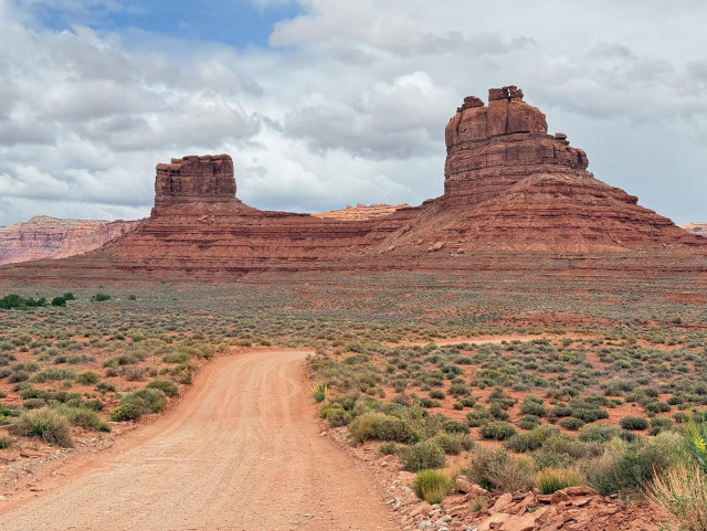 Photo of two large orange rock formations along a gravel road in Bears Ears National Monument, Utah USA. Photo ©Mary Nelson, 2026.