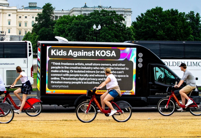 black van displays a "Kids Against KOSA" message with a quote about digital privacy, while people ride bicycles in front of it, with the Capitol building in the background.