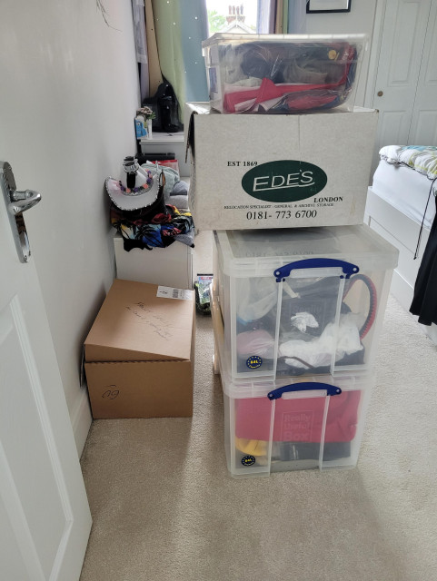Boxes full of various outfits and wigs