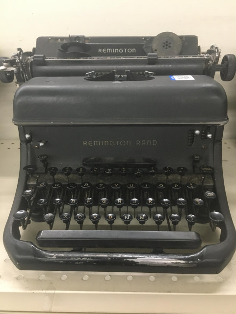 A silverish-gray Remington Rand typewriter.