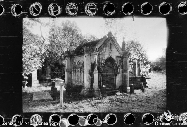 Photo of graveyard in black and white, crypt