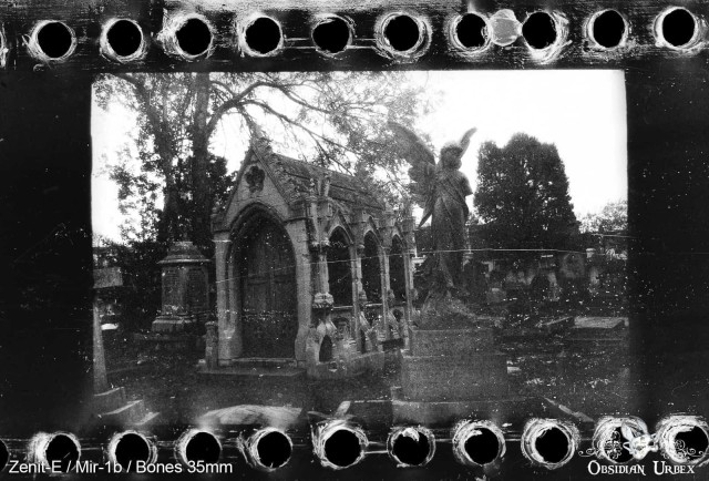 Photo of graveyard in black and white, crypt and angel statue
