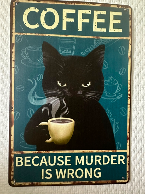 Retro picture of a black cat holding a white cup by the handle. The cup contains steaming black coffee.

Top of the picture has the text: "Coffee" and the bottom the text "Because murder is wrong"