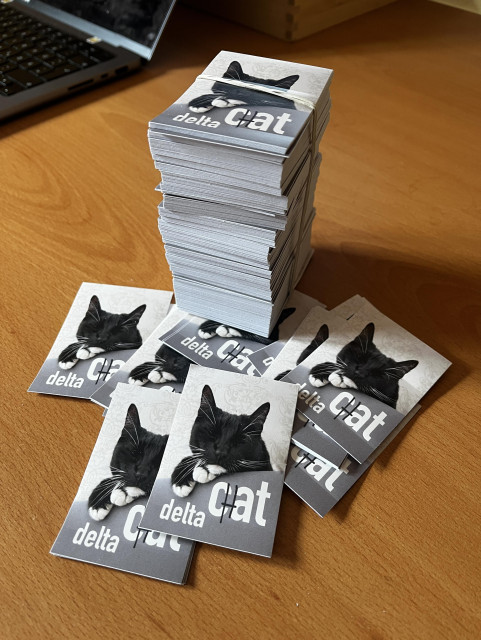 stickers with a cat and the text "delta cat" with an added "h" so it finally reads "delta chat"