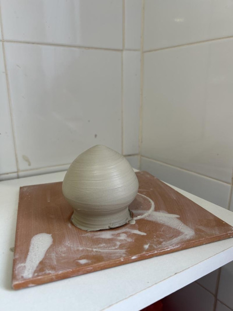Raw pottery tear-shaped salt shaker.
