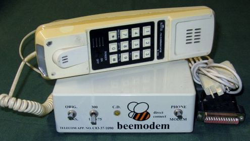 Acoustic modem with push-button handset sitting on top. Logo of bee with "beemodem" text.