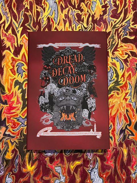 OF DREAD, DECAY, AND DOOM, an anthology of horror fiction edited by Jendia Gammon, Gareth L. Powell, and Scarlett R. Algee. Cover art: Niall C. Grant, with a dark red background and silver banner designs, featuring horror elements like ravens, skulls, tombstones, candles, and a demonic creature with flames in its mouth. With interior illustrations by Ahmed Raafat and Jendia Gammon. Underneath the book is a mixed media piece of art by Jendia Gammon, featuring flames and lightning bolts and other abstract imagery in reds, golds, black, silver, blue, and orange.