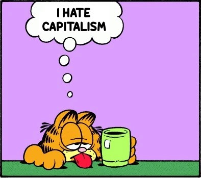The cartoon cat Garfield, exhausted, leaning on a table with tired eyes and his tongue hanging out, holding onto a cup of coffee. His thought bubble reads: “I hate capitalism”.