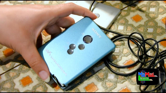 Maddi's hand holding a beautiful blue Sony walkman WM-EX610