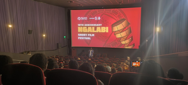 Photo of a cinema hall, with the logo of a film festival up on the screen and the text 10th Anniversary, Ngalabi Short Film Festival