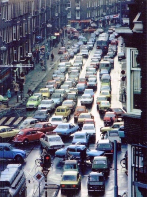 Wide Amsterdam Road filled with jammed colourful cars, stuck in traffic congestion.