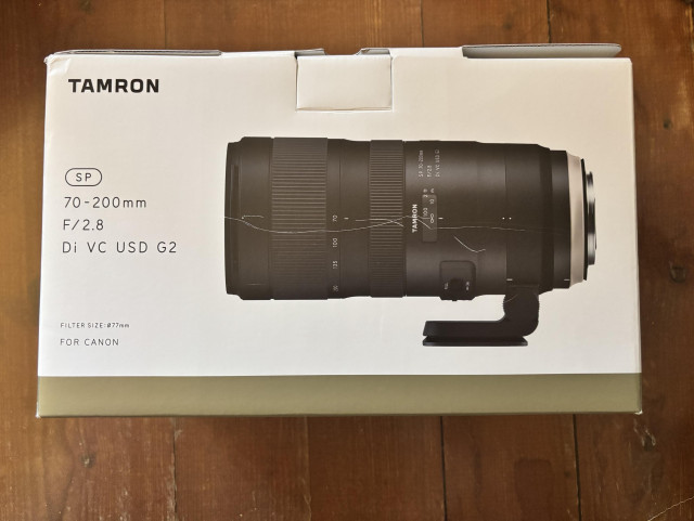 A packaging box featuring a Tamron SP 70-200mm F/2.8 Di VC USD G2 lens, designed for Canon cameras. The box displays an image of the lens with specifications including filter size and focal length.