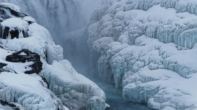 The second colour photo is of the icicles and cakes of ice at the point on the canyon wall next to the top falls. The ice is quite turquoise due to the fact that it's constantly wet. Snow has settled on the upper surfaces of the icicles. Some black rock is showing through in a few places, but mostly the ice is dominant. Running water can be seen at the top left.