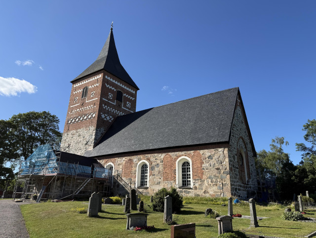 Photo of a stone church with scaffolding. 
