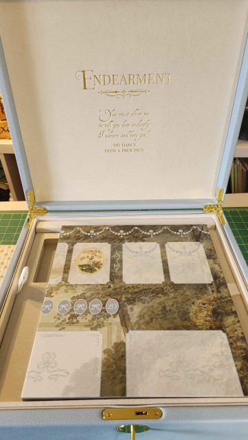 The box opened, showing an inscription under the game title - Endearment. "You must allow me to tell you how ardently I admire and love you" Mr Darcy Pride and Prejudice.