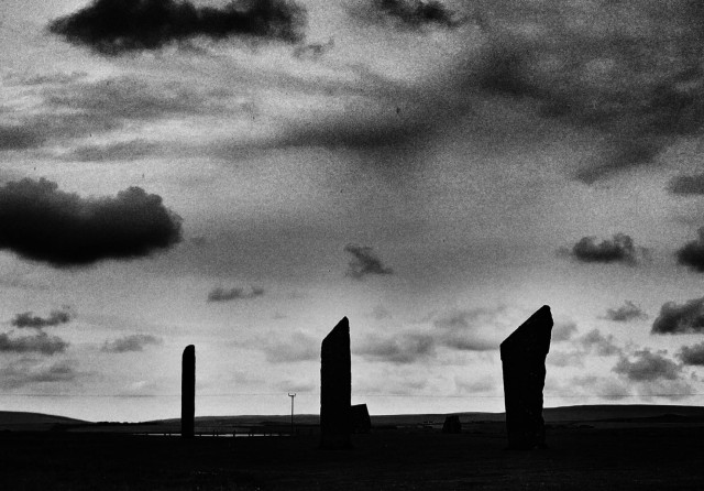 Henge stones silhouetted against sky.
