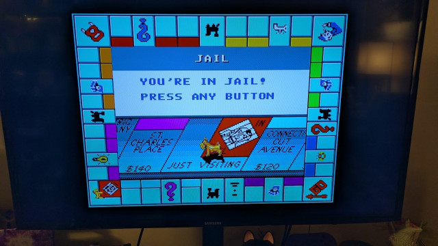A picture of Monopoly on Sega Genesis on the TV. I've gone to jail and the text says "You're in jail! Press any button."