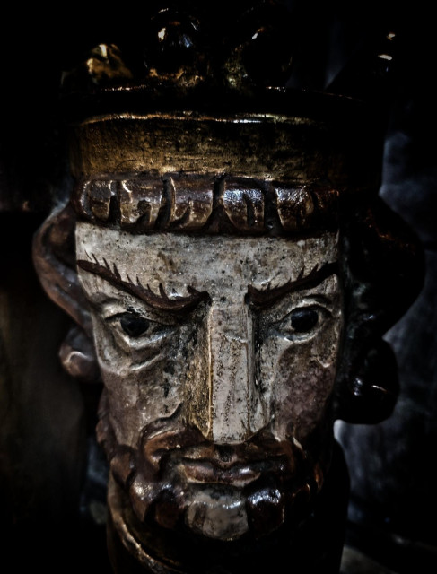 Painted wooden head of king
