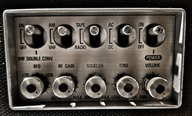 Metal switches and knobs of old radio interface. Includes squelch control.