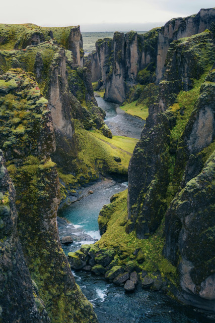 The moss covered Fjaðrárgljúfur, a massive, steep-walled canyon located in South Iceland. It was carved out roughly 9,000 years ago during the last Ice Age as glacial meltwater eroded the soft volcanic bedrock.