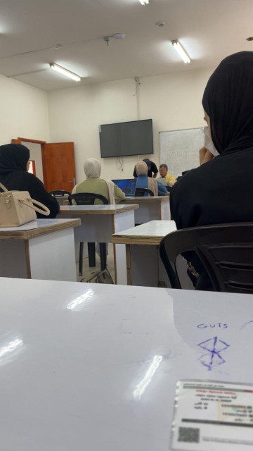 A classroom and female students in Gaza