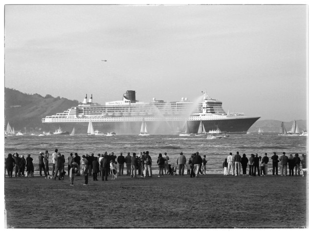 A giant cruise liner enters the San Francisco Bay, surrounded by dozens of small boats. A helicopter flies overhead. Water from fire boats greets the ship. And people line up on the shore, watching the arrival with great interest. It was so exciting 🙄

Monochrome, because history always looks more historical when things are photographed in black and white.