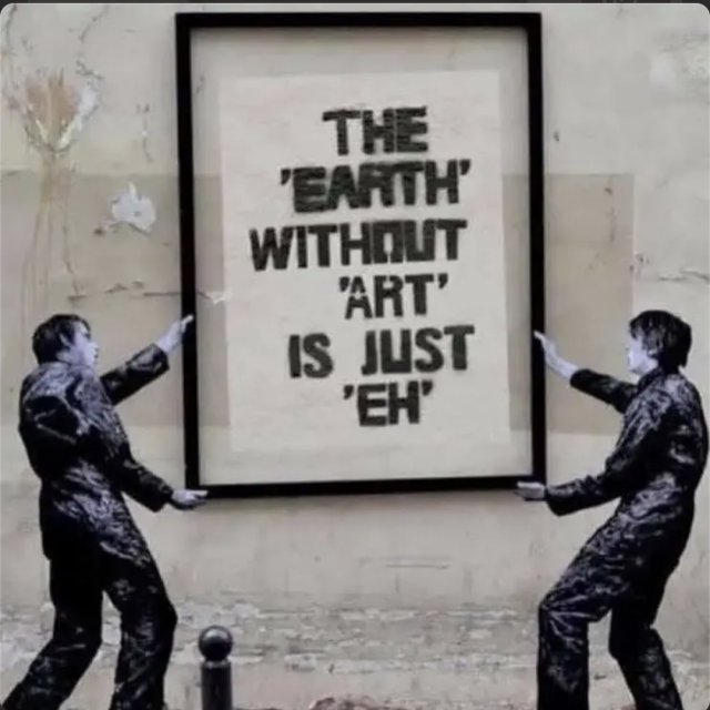 Banksy style mural showing two people in black overalls hanging up a huge framed poster that says "The "earth" without "art" it just "eh"