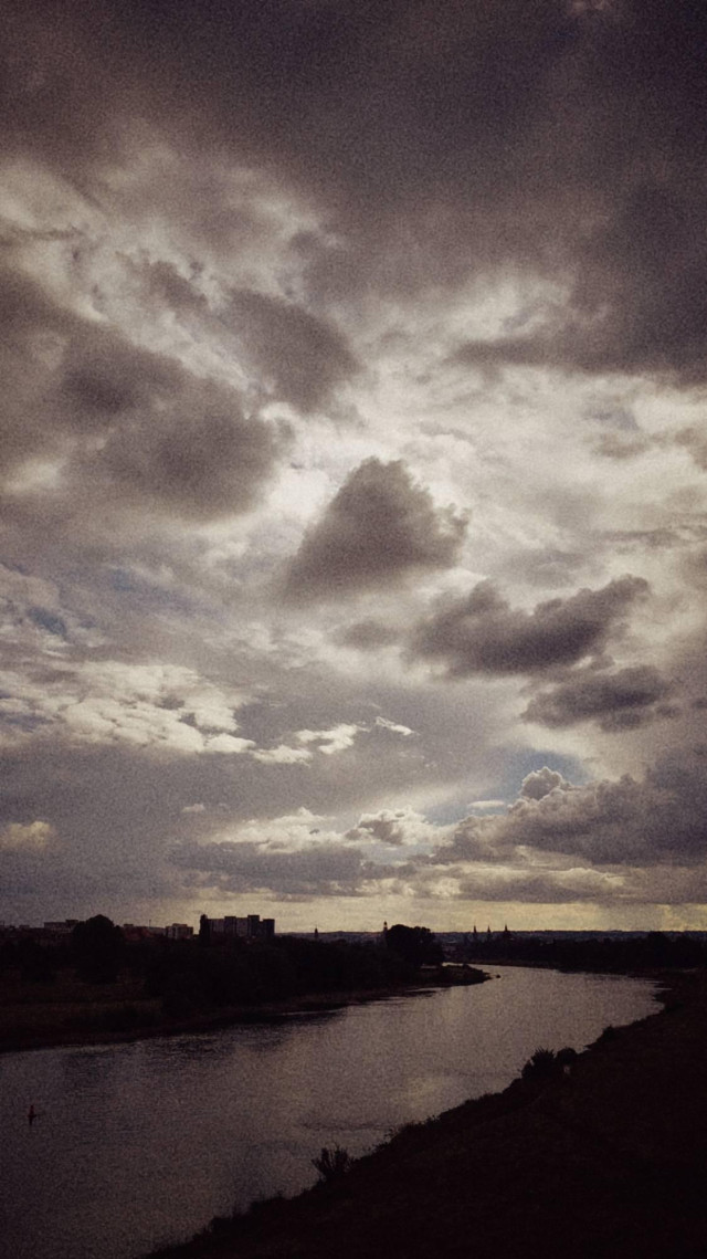 A river in late afternoon light. Clouds above.