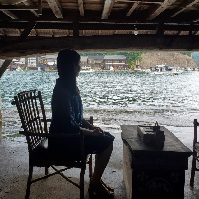 Nao-san enjoys coffee in one of the old 'Funa-ya', houses designed so that boats could be pulled directly from the sea into the ground floor.
