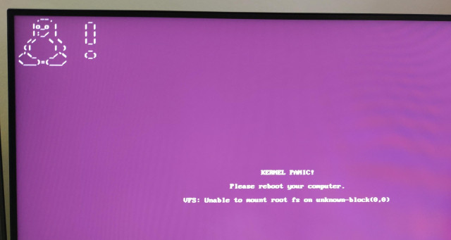 Photo of my screen, it is the purple screen of death with the Linux penguin in the corner and text saying "KERNEL PANIC! Please reboot your computer unable to mount root fs " etc