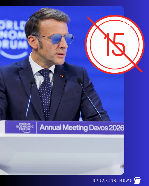 French President Emmanuel Macron wearing glasses and speaking on stage at the Annual Meeting Davos 2026. Next to him is a sign showing no under 15s. 
