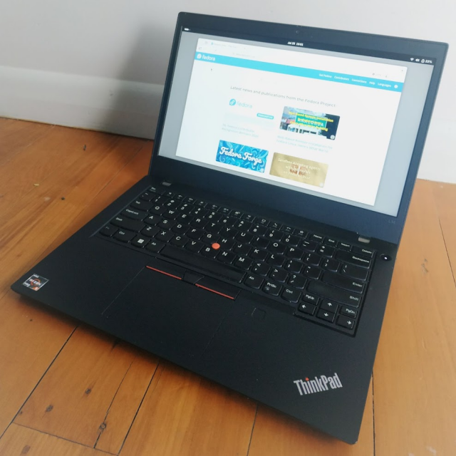 Lenovo ThinkPad L14 laptop, open displaying the Fedora.org start page https://fedoraproject.org/start/