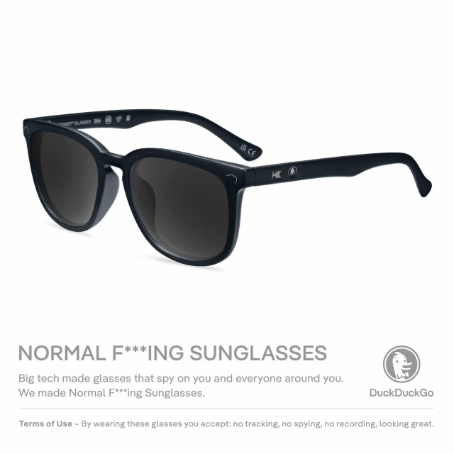 An add for a pair of black tinted sunglasses in a black plastic frame. Text reads:

NORMAL F***ING SUNGLASSES
Big tech made glasses that spy on you and everyone around you. We made Normal F***ing Sunglasses.
DuckDuckGo Terms of Use - By wearing these glasses you accept: no tracking, no spying, no recording, looking great.