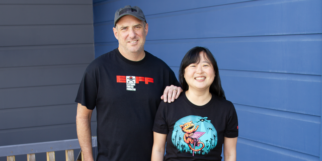Two people wearing new EFF t-shirts. DEF CON 34 and Claw Back.