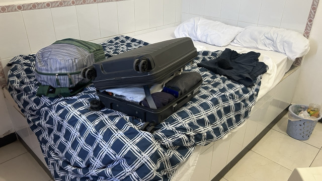 My suitcase on the bed in the familiar, too stuffed to close easily Pac-Man open-mouth formation