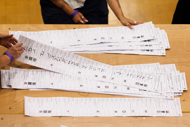 A spoiled ballot from last nights' election. Across the longest voting slip in UK history is written :"What a disgraceful waste of money" 

Election workers sort through spoiled ballots at Clacton Leisure Centre after the voting closed. Photograph: Dan Kitwood/Getty Images