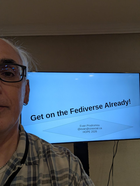 Me standing in front of a slide that says "Get on the Fediverse Already!"