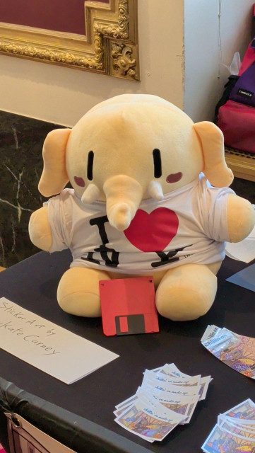 A Plushtodon plushie wearing an "I Love New York" shirt with a 1.44MB (you read that right) in front of it.