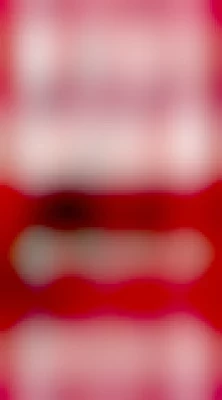 The front cover of the novel Jurassic Park, by Michael Crichton. It's an old cover that doesn't reference the film franchise. It's red, with a dinosaur skeleton (presumably a T-Rex) silhouette on the front. 