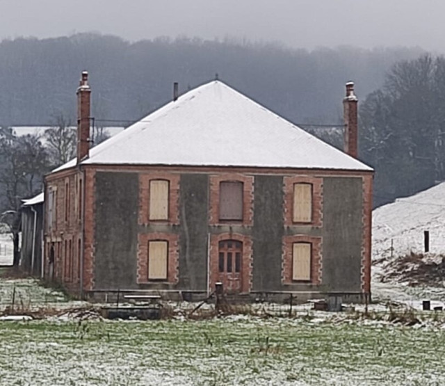 House, built around 1900 in snowy landscape. 