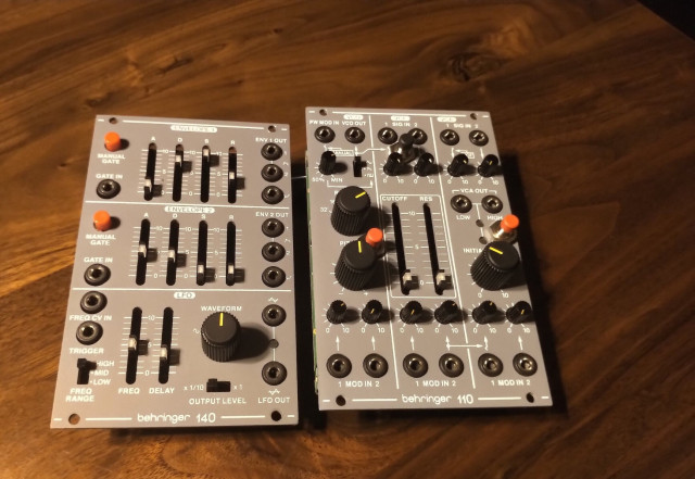 A Behringer 140 envelope generator and 110 vco Vcf Vca. Red buttons added to the 110 match the style of those on the 140
